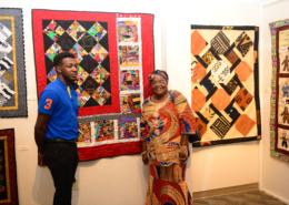 Edna C. Alston stands by her quilt in the 20 Years of Harmony: Stitches of a Quiltessential Sisterhood exhibit.